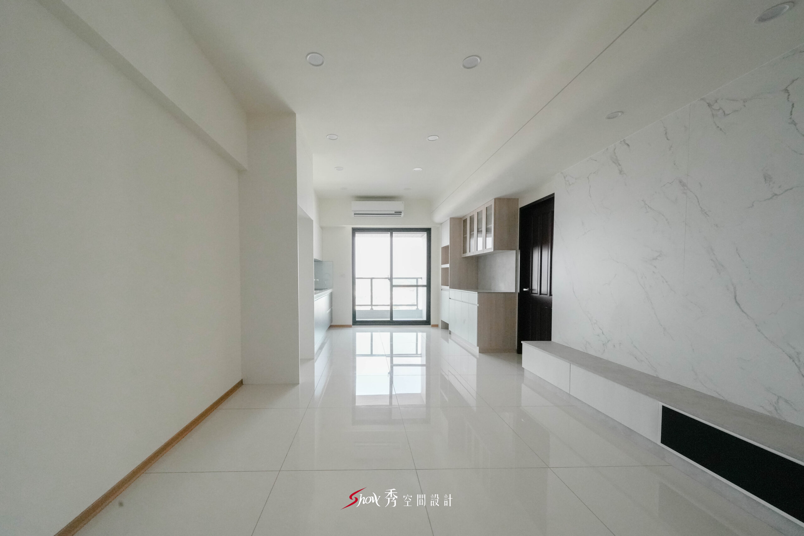 客餐廳採白色亮面地坪搭配大理石紋電視牆與淺木收納櫃，營造明亮大器的公共空間。