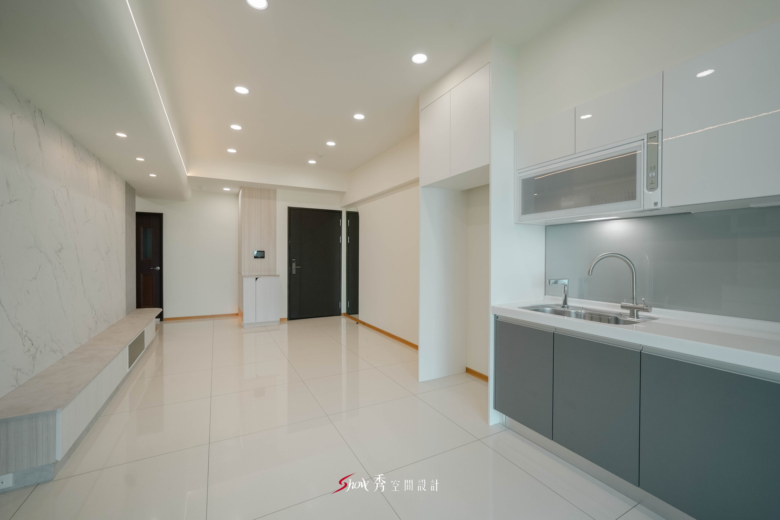 開放式客餐廳與廚房結合，搭配嵌入式電器與整齊櫃體設計。